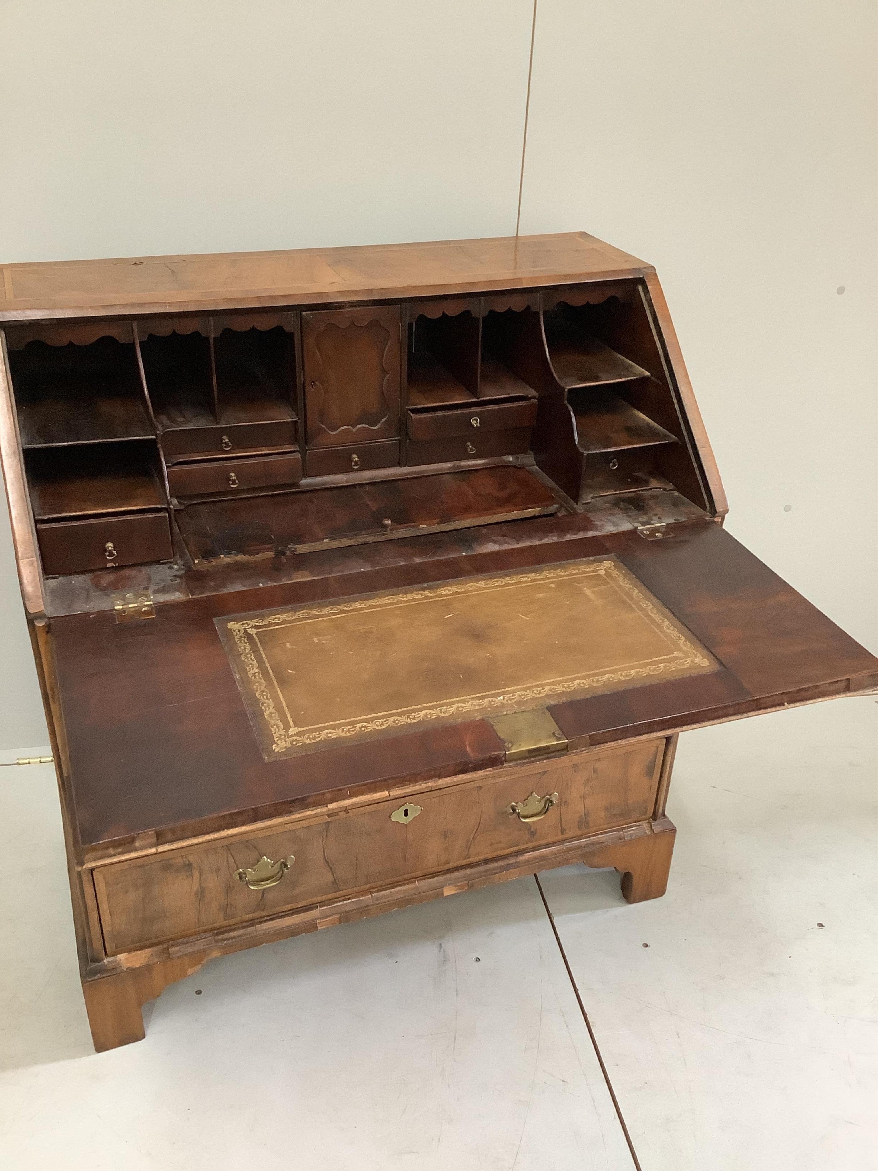 An 18th century feather banded walnut bureau, width 92cm, depth 50cm, height 100cm